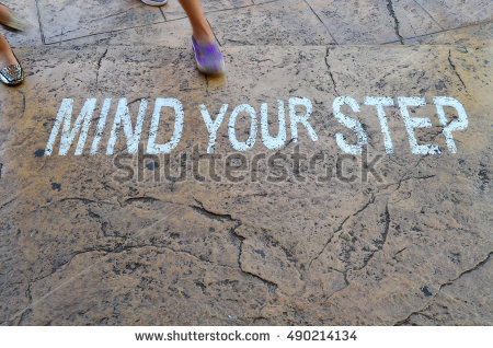 stock-photo-white-painted-warning-sign-on-step-stating-mind-your-step-with-defocused-woman-leg-safety-sign-490214134.jpg