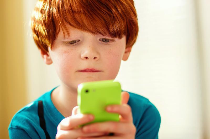 young-boy-4-5-playing-mobile-game-on-his-mothers-phone.jpg
