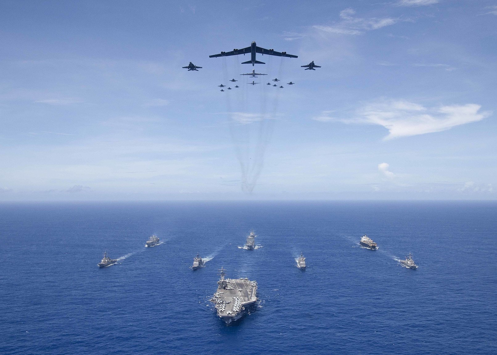 2560px-B-52_and_FA-18_aircraft_flying_over_the_Carrier_Strike_Group_Five_during_Valiant_Shield_2018.jpg