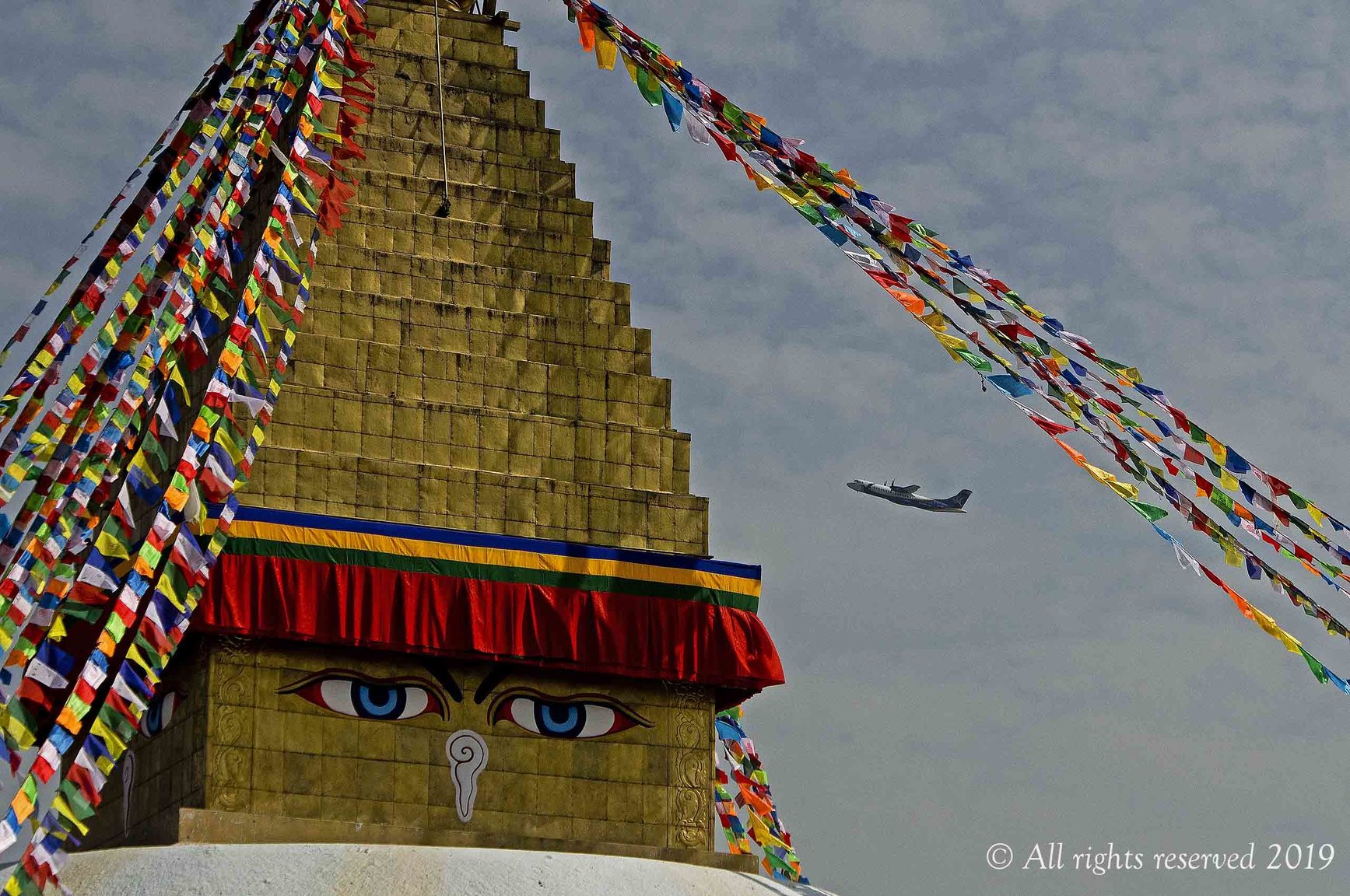 Bodhanath  Buddha eyes with airplane.jpg
