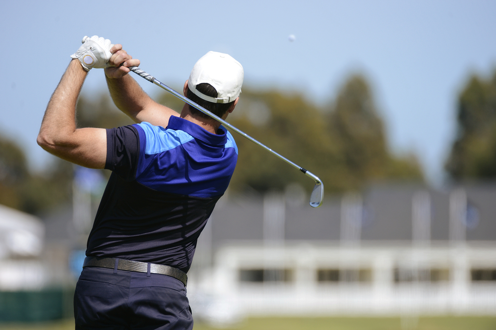golf_Golfer hits an fairway shot towards the club house.jpg