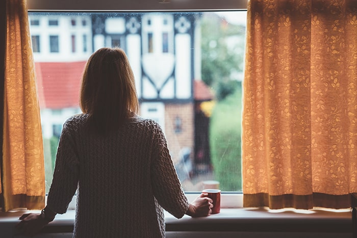 isolation-woman-with-coffee-behind-windows.jpg