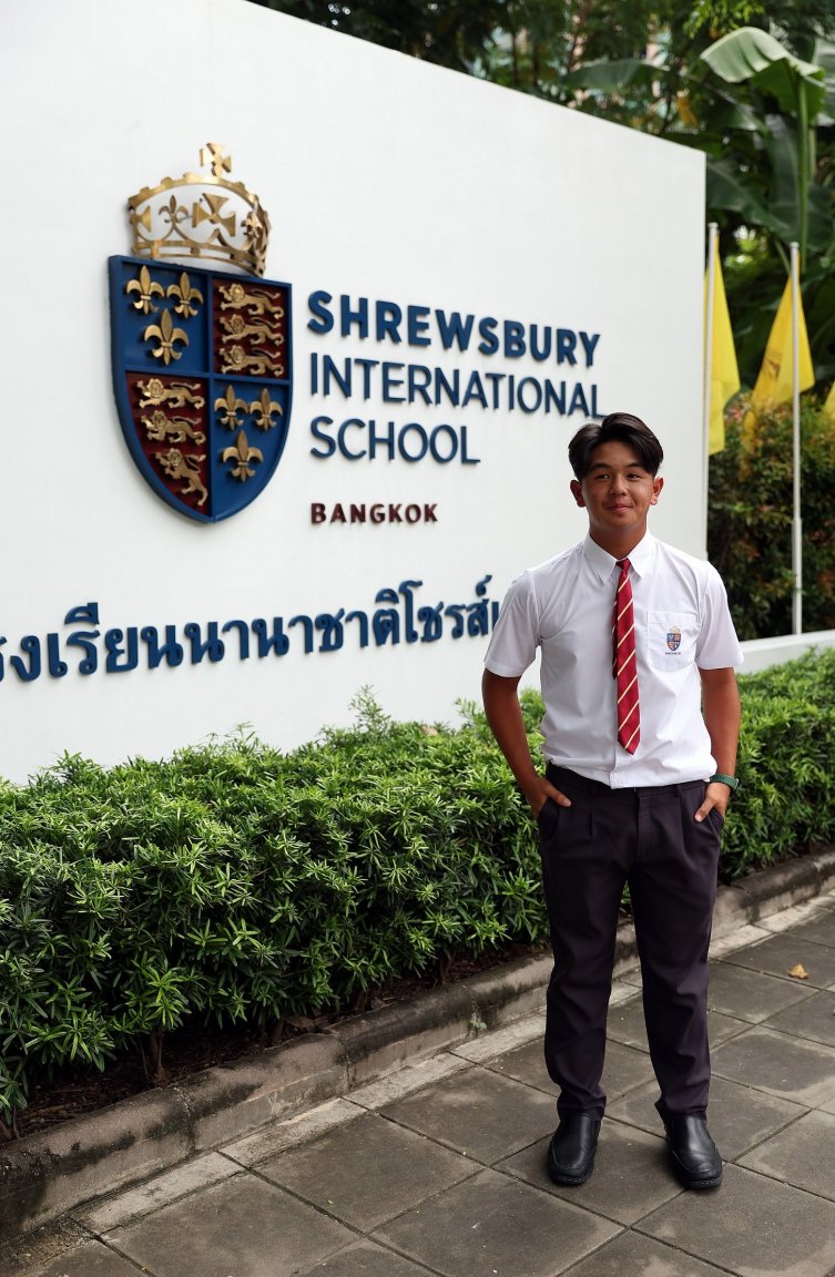 15-year-old TK outside the Shrewsbury International School in Bangkok, where he is still a pupil.JPG