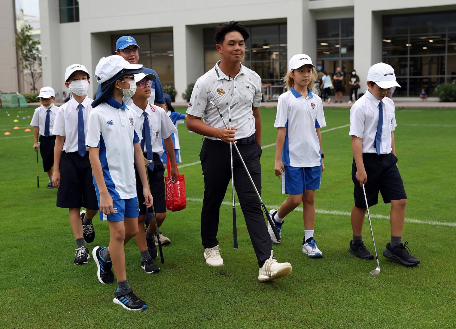 TK gave the young pupils free hats - plus tickets for them to attend this week's tournament with their families.JPG