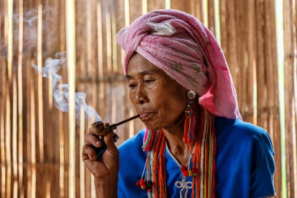 female-karen-hill-tribe-is-smoking-tobacco-pipe-traditional-in-the-cottage-of-northern-thailand.jpg.05de776f5eb7356e177ac725c4a34b1e.jpg