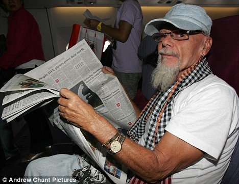 gary glitter reading paper on aircraft.jpg