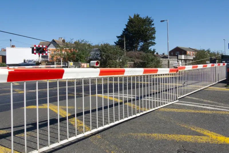 level-crossing-gates-over-road-crosing-closed-down-worthing-west-sussex-england-460360035.webp